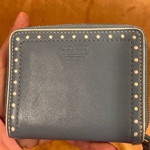 Small coach zip around wallet. This is a baby blue with white circles etching.